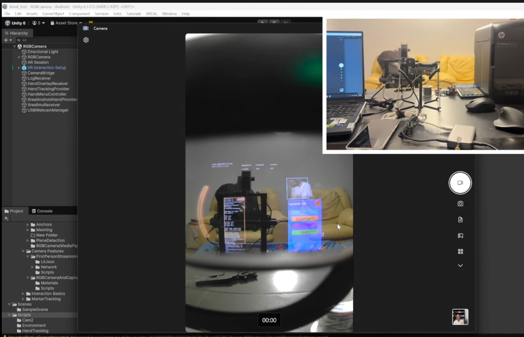 Development software showing a camera view through glasses, alongside a desk with a wired prototype, laptop, and phone.